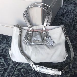 White and silver coach satchel.